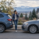 Denver UIM claim settlement concept with a driver beside a car on a Denver street